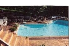 Multi level decks, brick pool deck, stone walls and plantings in Inverness